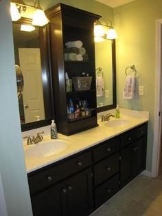 a bathroom with two sinks and a large mirror