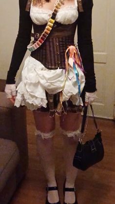 a woman dressed up as a steampunk holding a purse and posing for the camera