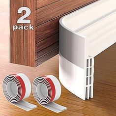 two pieces of white plastic adhesive tape next to a wooden door with 2 packs of red and white adhesive tape