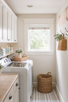 a white washer and dryer sitting in a kitchen next to a window on the wall