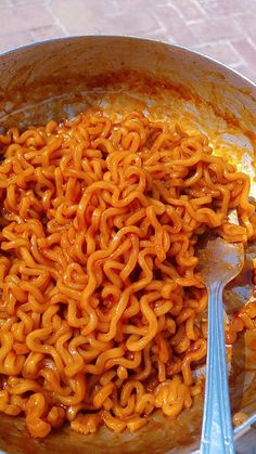 a bowl filled with noodles on top of a table