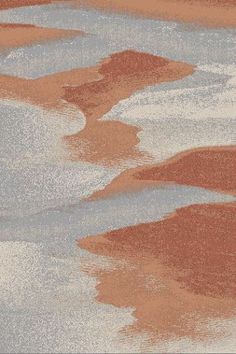 an orange and white area rug with water reflection on it