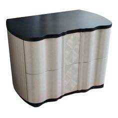 an unusual black and white cabinet with drawers