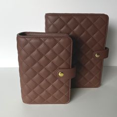 two brown wallets sitting next to each other