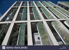 an apartment building with green plants on the balconies