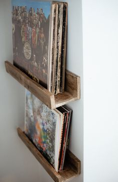 two wooden shelves holding various records and cds