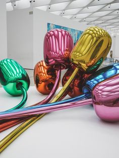 colorful glass vases sitting on top of a white table