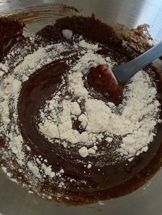 a mixing bowl filled with chocolate and powdered sugar