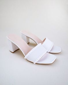 "Classic satin slip on block heel sandals adorned with pearls on the vamp for romantic, elegant and feminine look. The delicate pearl beads are placed carefully by hand to create a graceful classic style. Simple and easy wear for bridal wear, bridesmaids, holiday party, wedding parties, and any special occasions.  DETAILS: HEEL HEIGHT: 2.5 Inches COLORS AVAILABLE: Ivory and White UPPER: Synthetic upper and lining MATERIALS: Manmade outsole STYLE NAME: VERONA Not sure of which size to purchase? Shoes measurements are as follow: (Please note measurements taken the length of inside of shoe from toe to heel) Size 5.5 - 9\" Size 6 - 9.25\" Size 6.5 - 9.375\" Size 7 - 9.5\" Size 7.5 - 9.625\" Size 8 - 9.75\" Size 8.5 - 9.875\" Size 9 - 10.125\" Size 10 - 10.375\" Size 11 - 10.75\" - We DO NOT of Cheap White Sandals With Block Heel, Luxury White Block Heels For Party, White Small Heel Sandals, Elegant Pearl Embellished Block Heels, White Pearl Open Toe Heels, Elegant Pearl-embellished Open Toe Sandals, Summer Wedding Pearl Heels, Elegant Summer Wedding Shoes For Bridesmaids, Summer Pearl Embellished Block Heel Heels