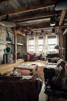 a living room filled with furniture and lots of windows