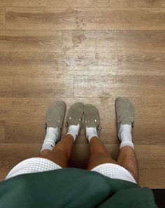 a person standing on top of a wooden floor