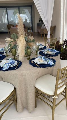 the table is set with blue and white plates