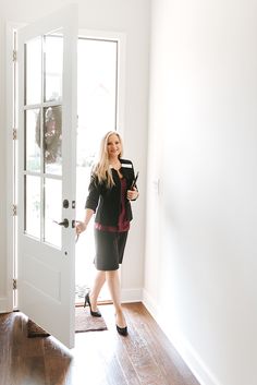 a woman is standing in front of the door