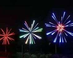 fireworks are lit up in the night sky with red, white and blue lights on them