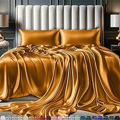 a bed covered in gold sheets and pillows