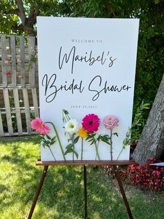 a sign with flowers on it that says, welcome to marbel's bridal shower