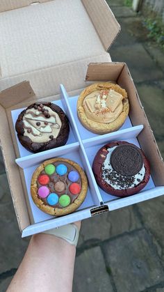 an open box filled with different types of cookies