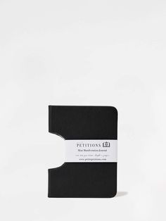 a black notebook sitting on top of a white surface