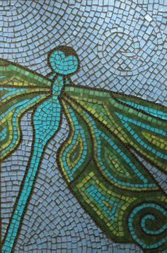 a blue and green mosaic with a dragon on it