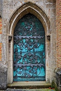 an old church door with ornate iron work