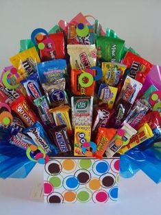 a colorful candy bouquet in a polka dot box