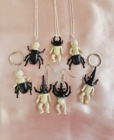 Super cute n creepy mutant beetle babies! Soooo creepycute and pastel goth! Each unique piece is handmade and one of a kind, some beetle babies are more beetle and some are more baby, some have baby bodies and some have bug bodies. They feature pinchers like a stag beetle or rhinocerous beetle, and have creepy beetle-like bodies and legs fusing with the human-like baby body parts. Keychains, necklaces, and earrings available!! Feel free to contact me about switching around the style for example swapping a necklace to a keychain. The beetle baby creatures measure approx 5cm in length. There are several styles available so please refer to the last photo when choosng a style number! :) They are a lovely gift for any pastel goth babe or appreciator of creepycute things! xoxo Cute Handmade Halloween Jewelry, Quirky Handmade Halloween Jewelry, Immaculate Vibes, Bug Gifts, Jewelry Keychain, Goth Necklace, Keychain Necklace, Stag Beetle, Baby Body