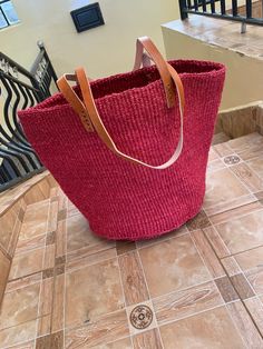 Kiondo overview A beautiful hand made kiondo bag in Cherry red color. A wonderful art piece for your everyday activities and a great gift for a loved one. The bag is made of sisal fiber that is hand picked hand prepared into yearn then twisted and weaved. It is finished with natural leather mainly from cow hide. Uses Day out: Its a great bag for use in carrying personal effects such as outdoor mats,sandals and other picnic items Shopping: The bag has large space that can adequately accommodate y Handmade Red Bucket Bag For Summer, Handmade Red Beach Bag For Everyday, Red Handmade Bucket Bag For Beach, Red Rectangular Bucket Bag For Travel, Eco-friendly Red Shoulder Bag For Shopping, Eco-friendly Handmade Red Bag, Red Handmade Bags For Summer, Handmade Red Bags For Summer, Eco-friendly Red Handmade Bags