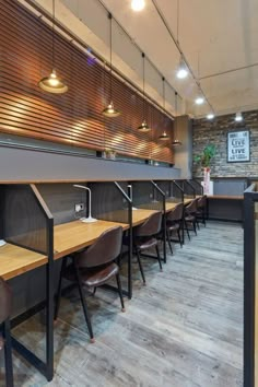 an empty restaurant with wooden tables and chairs