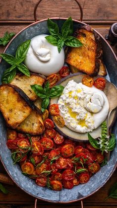 a plate with bread, tomatoes and eggs on it