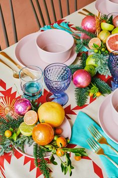 the table is set with fruit and silverware for an elegant holiday dinner or celebration