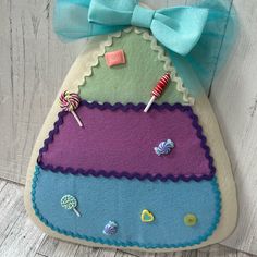 a felt bag with candy and candies on the front is hanging on a wall