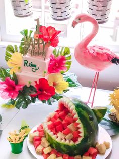 a watermelon, melon, and pineapple slice shaped like a flamingo