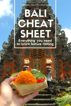 someone holding up a bowl with food in front of an ornate building that says bali heat sheet everything you need to know before visiting