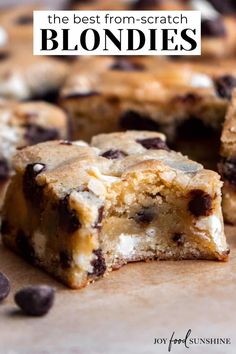 chocolate chip cookie bars cut in half on top of brown paper with white icing