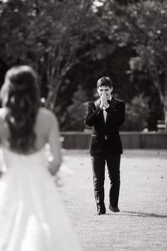 a man in a suit and tie standing next to a woman wearing a wedding dress