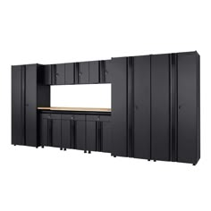 an empty room with black cabinets and white walls