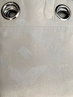 a silver purse with two metal rings on the front and one in the back pocket