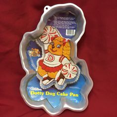 a cake pan shaped like a teddy bear holding a candy cane