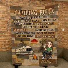 a woman sitting on a couch next to a brick wall with a camping rules sign