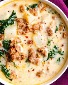 the best copycat zuppa toscana soup is in a white bowl with spinach and cheese