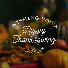 a happy thanksgiving card with pumpkins, apples and other holiday foods in the background