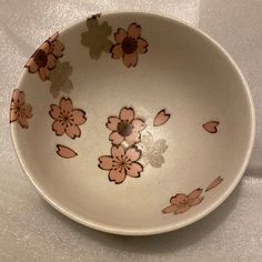 a white bowl with pink flowers on it