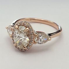 an engagement ring with three pear shaped diamonds