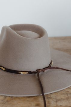 These unique bands feature 3/8" chocolate brown grizzly leather with gemstones attached by hand approximately every 2 inches. Leather ties in back make them adjustable to any hat size. Material: Genuine grizzly leather Hardware: Jasper stones, silver or gold jump rings Dimensions: 34" total length, 22" band length with stones before adjustable tie closure. Closure: Leather ties Luxury Everyday Brimmed Hat Bands, Cheap Brown Hat Bands For Men, Luxury Brown Hat Bands For Travel, Luxury Beige Hat Bands For Ranch, Luxury Wool Hat Band With Flat Crown, Luxury Rustic Hat Bands For Men, Luxury Hat Bands For Fall, Luxury Brown Brimmed Hat Bands, Luxury Western Wool Hat Bands