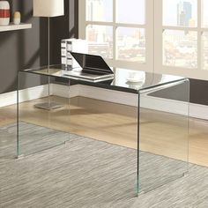 a glass desk with a laptop on it