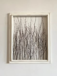 a white frame with some branches in it