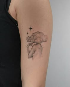 a woman with a cloud tattoo on her arm