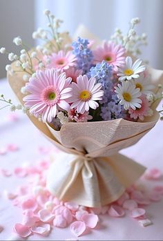 a bouquet of daisies and other flowers on a table