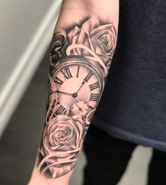 a person with a clock and roses tattoo on their arm