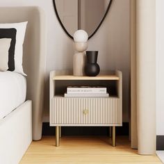 a nightstand with a mirror and vase on it